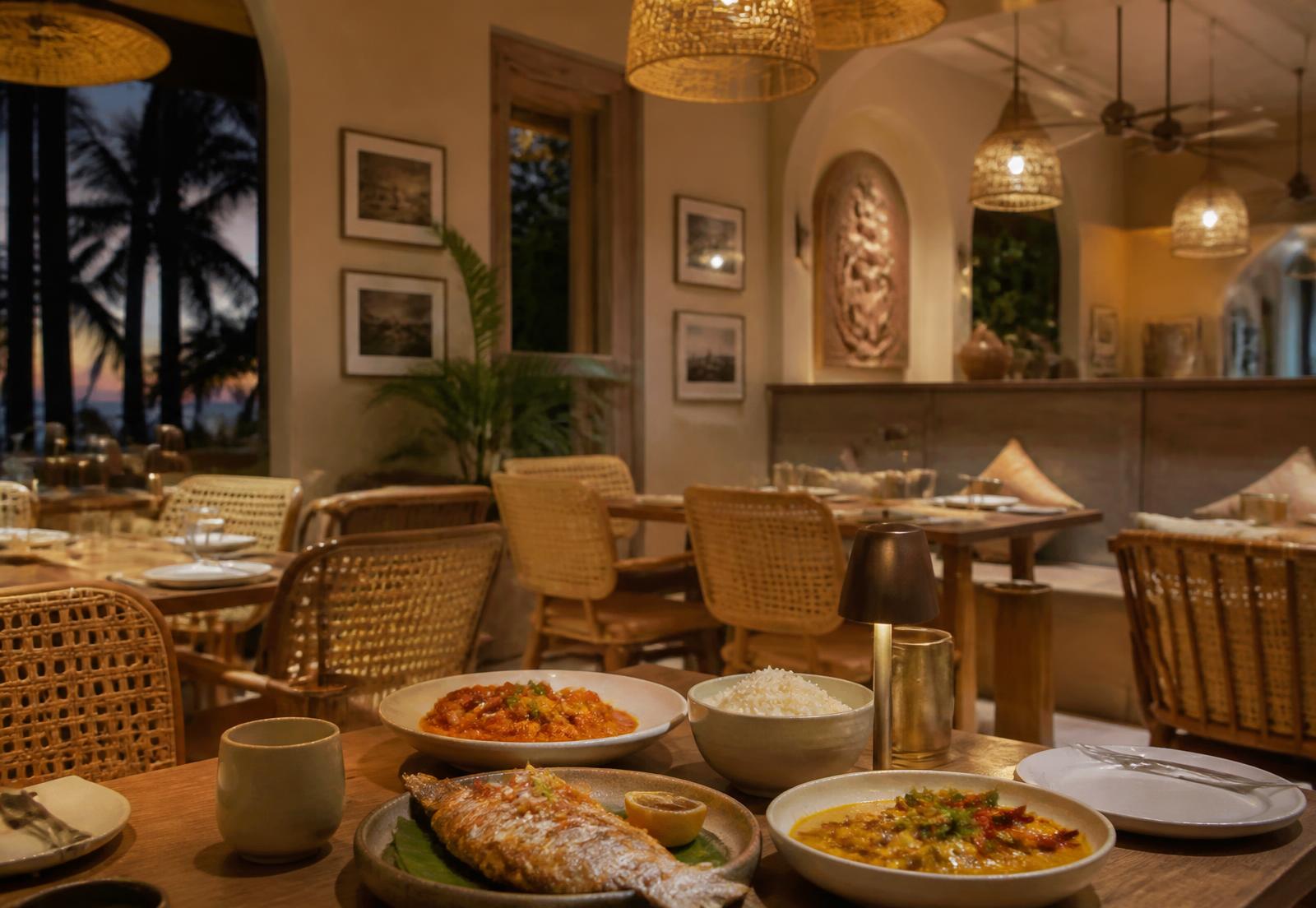 Warm contemporary coastal dining room in the evening